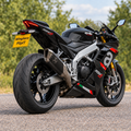 Aprilia RSV4 1100 with WingAero FlipIT motorised number plate bracket, woodland outdoor rear three-quarter view