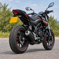 Benelli TNT 125 with WingAero FlipIt electric flip plate bracket in an outdoor setting, rear three-quarter view